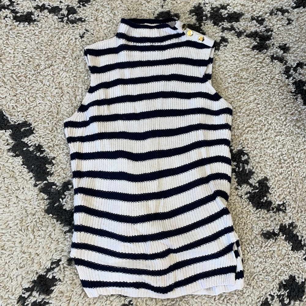 Navy and cream striped sleeveless sweater with gold button detail on shoulder